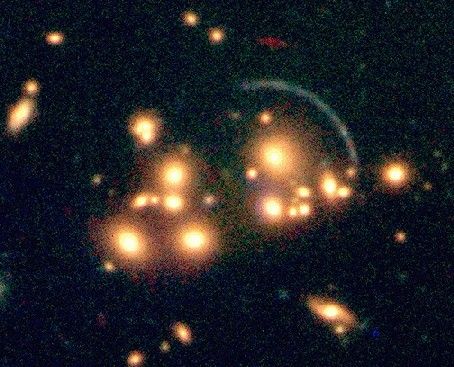 Galaxy image smeared into arc by gravitational lensing 454x367 48K